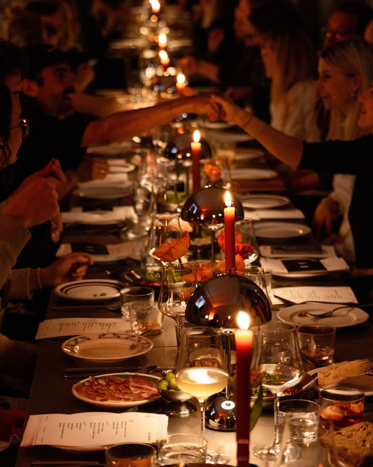 Guests gathered around a candlelit private dinner